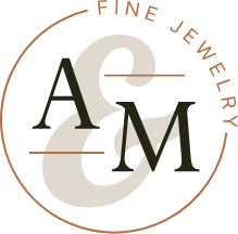 Small variation of Ana and Mia logo. Showing A & M with the phrase fine jewelry incircling it